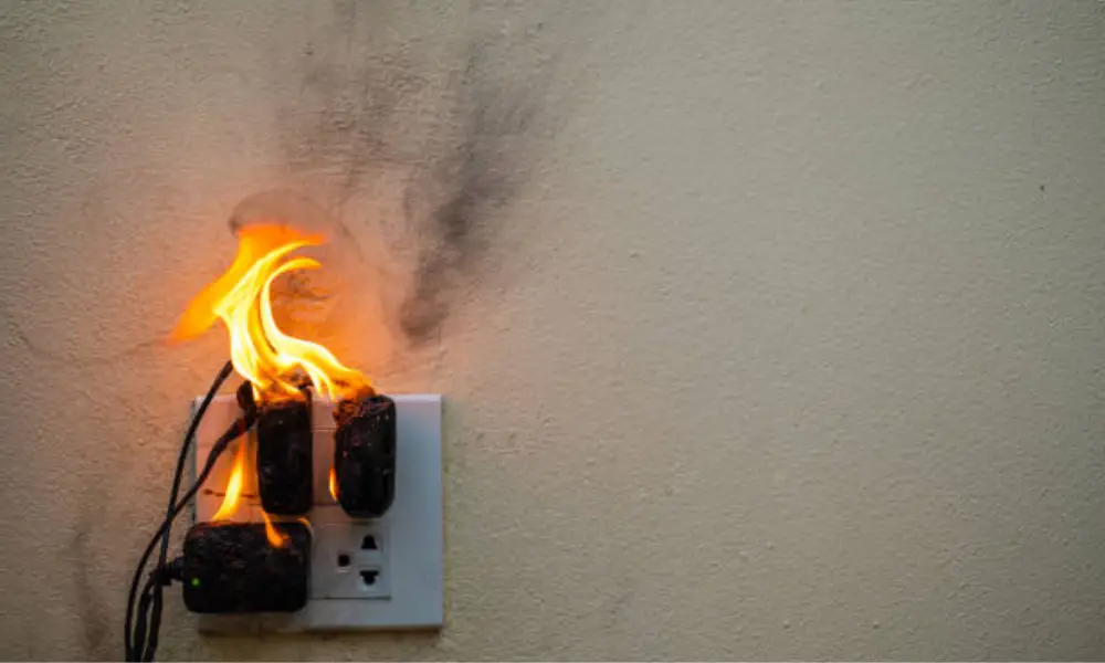 This image is used to describe that drilling into a live wire can result into a fire breakout from power outlets.